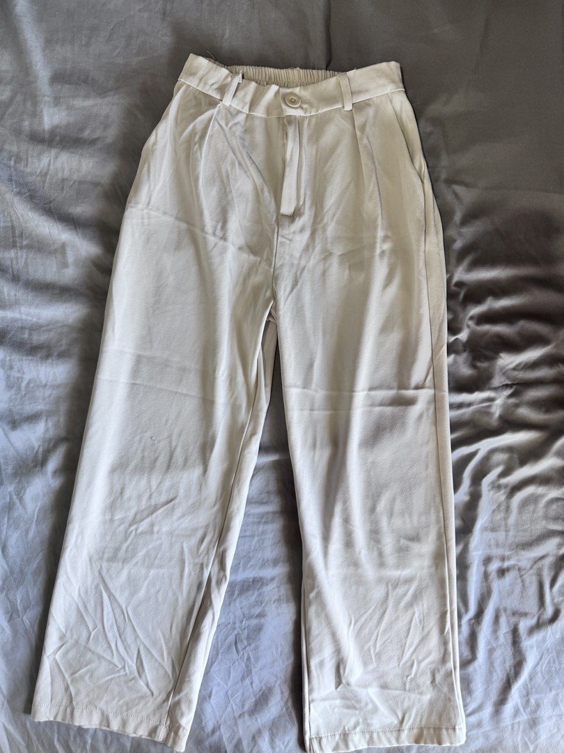 Cream High-Waisted Pleated Wide-Leg Pants (Category: Other Bottoms) located in Pasay City. Submitted by idaboutique (Listing ID 1451065862, Image 2). Description: - Cream colored pants - High-waisted with pleated front - Wide leg silhouette - Elasticated back waistband for comfort - Button and zip closure - Relaxed fit - Versatile: dress up or down.