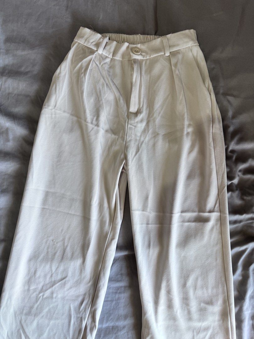 Cream High-Waisted Pleated Wide-Leg Pants (Category: Other Bottoms) located in Pasay City. Submitted by idaboutique (Listing ID 1451065862, Image 1). Description: - Cream colored pants - High-waisted with pleated front - Wide leg silhouette - Elasticated back waistband for comfort - Button and zip closure - Relaxed fit - Versatile: dress up or down.