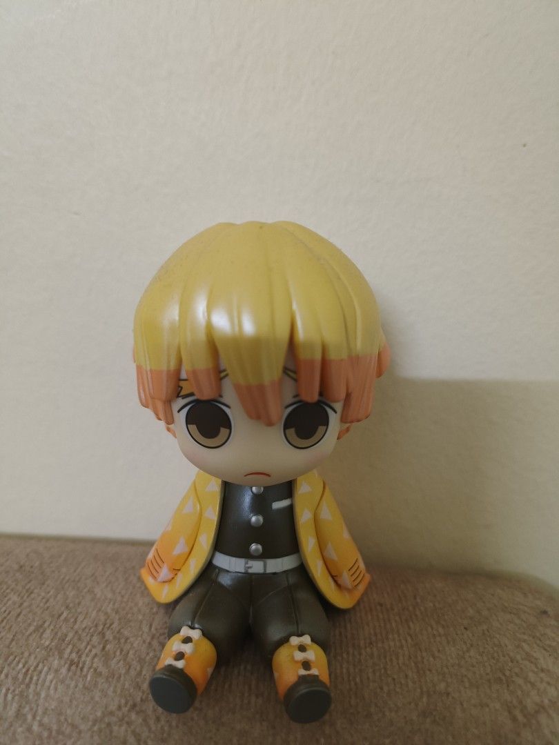 Demon Slayer Zenitsu Agatsuma Chibi Figure (Category: Toys & Games) located in Kuala Lumpur. Submitted by emi.03 (Listing ID 1450941793, Image 1). Description: - Cute Zenitsu Agatsuma figure from Demon Slayer - Chibi style, perfect for collectors - Features yellow hair with orange tips - Wears signature yellow haori with white triangles - Dressed in his black uniform - Sitting pose - A fun addition to any anime collection.