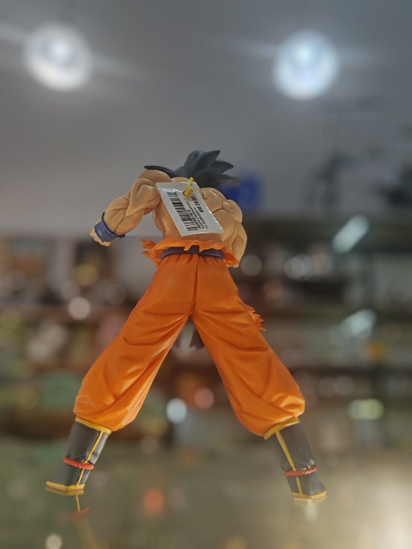 Dragon Ball Z Goku Action Figure (Category: Toys & Games) located in Kuala Lumpur. Submitted by iskandarkhan (Listing ID 1450977639, Image 3). Description: - Dragon Ball Z Goku action figure - Iconic orange gi with blue sash - Features detailed muscles and spiky hair - Posed dynamically, ready for battle - Comes with original tag attached - Essential for any Dragon Ball fan's collection.