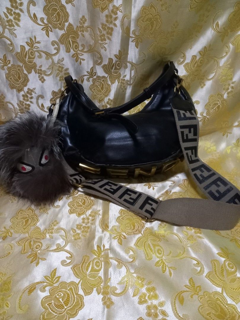 FENDI SHOULDER BAG NEED RESTORATION (Category: Luxury Bags & Wallets) located in Manila. Submitted by cristobalc40322 (Listing ID 1413041616, Image 1). Description: - Authentic Fendi shoulder bag - Black exterior with gold FENDI lettering - Features a brown and black Fendi logo strap - Red interior with zipper closure - Includes Fendi Roma tag and QR code tag COMPLETE AND ORIGINAL BUT NEED TO RESTORE STILL DURABLE LIGHTLY USED HINDE LANG NAITABI 