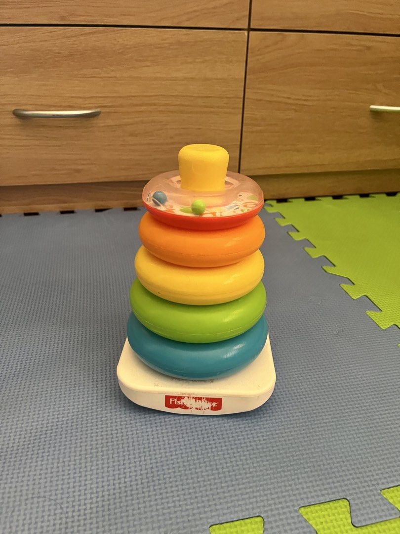 Fisher-Price Rock-a-Stack Stacking Rings Toy (Category: Infant Playtime) located in Bacolod City. Submitted by ellylacson (Listing ID 1450985134, Image 1). Description: - Classic Fisher-Price Rock-a-Stack toy - Includes 5 colorful stacking rings - Features a wobbly base for added challenge - Top ring has beads for sensory play - Excellent for developing fine motor skills and hand-eye coordination - In good, pre-loved condition and ready for a new