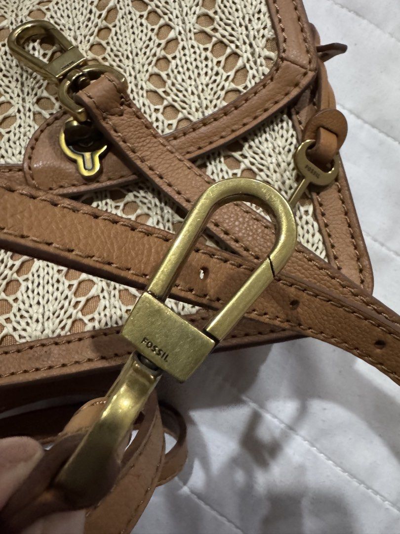 Fossil Woven Leather Crossbody Bag (Category: Cross-body Bags) located in Shah Alam. Submitted by prelovedbypunk (Listing ID 1451079417, Image 3). Description: - Cute Fossil crossbody bag - Tan leather trim with woven straw-like body - Secure turn-lock closure - Long, adjustable strap - Interior with multiple compartments - Small scuff marks on leather trim (adds character!) - Ideal for everyday wear and casual outings.