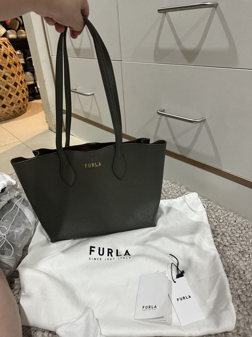 Furla Tote Bag - Green (Category: Luxury Bags & Wallets) located in Cebu City. Submitted by artitabysue (Listing ID 1450996380, Image 3). Description: - Authentic Furla tote bag - Beautiful olive green color - Genuine leather material - Comes with original dust bag and tags - Spacious interior with secure zip closure - Ideal for everyday use and travel.