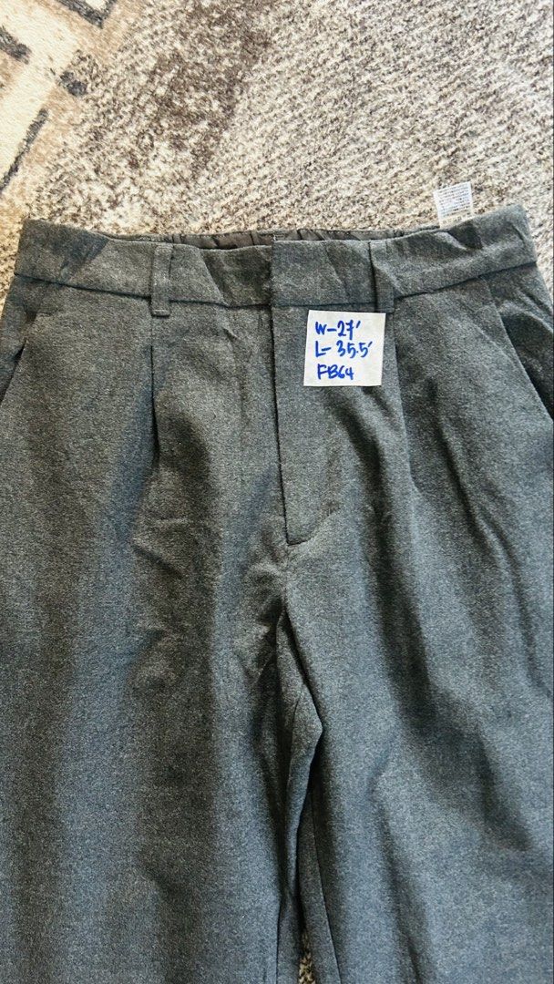 GU Grey Pleated Trousers Pants (Category: Other Bottoms) located in Kota Bharu. Submitted by thriftbyaffizahelmi (Listing ID 1450950684, Image 2). Description: - Grey trousers from GU - Features a pleated front - Elasticated back waistband for comfort - Made from a polyester blend fabric - Tag size: W-27 L-35.5 - Versatile for casual and smart casual outfits - Easy to style.