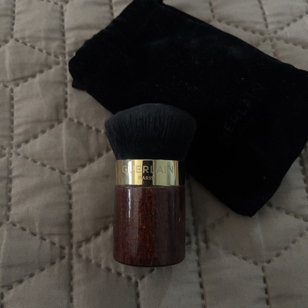 Guerlain Kabuki Makeup Brush with Pouch (Category: Makeup) located in Naga. Submitted by katalinaii (Listing ID 1450977870, Image 1). Description: Guerlain Kabuki Brush Purchased at Greenbelt 5 in 2023 Brush is in great condition Wooden handle with gold accent Compact size Comes with original black velvet pouch, just a bit flaky on the inside already Original price was about 3,500 Only used a few times.