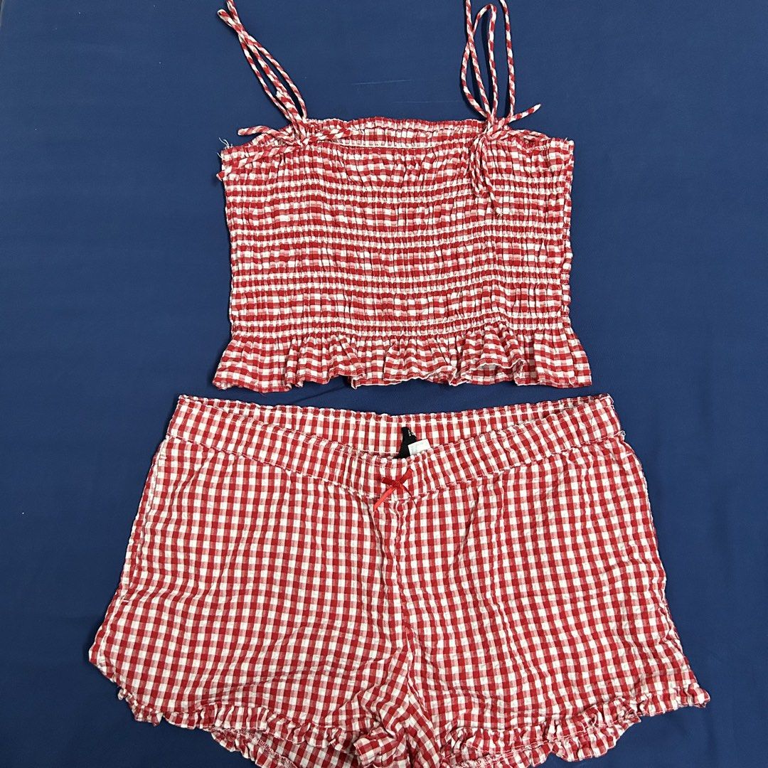 H&M Red Gingham Smocked Cami & Shorts Set Size L (Category: Sets or Coordinates) located in General Trias. Submitted by shop.nikki (Listing ID 1451078666, Image 1). Description: - Adorable H&M red and white gingham pajama set. - Features a smocked cami top with adjustable tie straps. - Matching shorts with a cute ruffled hem and a small bow accent. - Perfect for comfortable and stylish lounging. - Size: Large (L) bottoms and S top.