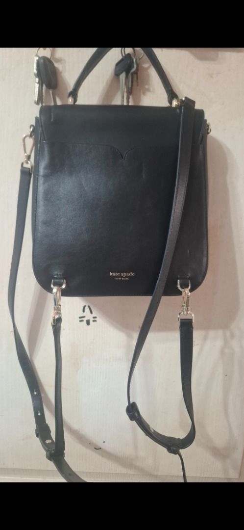 Kate Spade Black Leather Convertible Backpack Handbag (Category: Luxury Bags & Wallets) located in Cavite. Submitted by chinkee0215020 (Listing ID 1450945205, Image 2). Description: - Genuine black leather Kate Spade bag - Convertible: Wear as a backpack or shoulder bag - Additional top handle for carrying options - Multiple interior compartments for organization - Elegant gold hardware - Note: Minor scuffs on the front flap - Interior is clean a