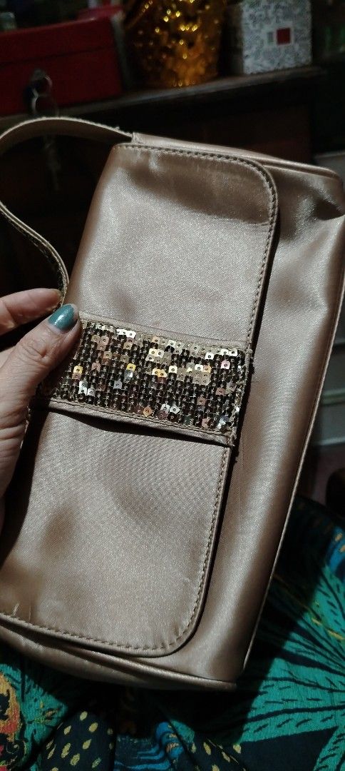 Lancome Paris Satin Clutch Bag with Sequins (Category: Clutches) located in Manila. Submitted by santanking (Listing ID 1451093087, Image 3). Description: - Chic satin clutch bag from Lancome Paris - Elegant champagne/light gold color - Eye-catching sequined detail on the front flap - Features a convenient single strap - Secure zipper closure inside - Ideal for evening events and special occasions #Lancome #everyone #followers #follower #foryoupa