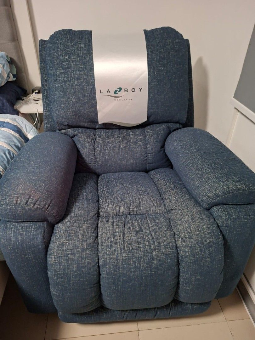 La-Z-Boy Recliner - Blue Fabric (Category: Chairs) located in Taguig. Submitted by kitin1218 (Listing ID 1451040087, Image 1). Description: - Comfortable La-Z-Boy recliner - Nice blue textured fabric - Padded arms and back for extra comfort - Smooth reclining mechanism - Perfect for relaxing after a long day - Fits well in most living rooms - Selling because it's no longer needed -Seldome used 📍Taguig.