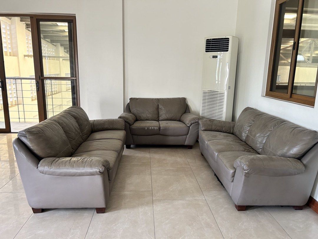 Leather Sofa Set (Category: Sofas) located in Mandaluyong City. Submitted by jamieapple (Listing ID 1451030410, Image 2). Description: - Comfortable leather sofa set - Includes: 2 3-seater and 1 2-seater - Color: Neutral grey-brown, versatile for any decor - Ideal for living rooms or waiting areas - Note: Some wear on the middle sofa cushion - Location: QC.