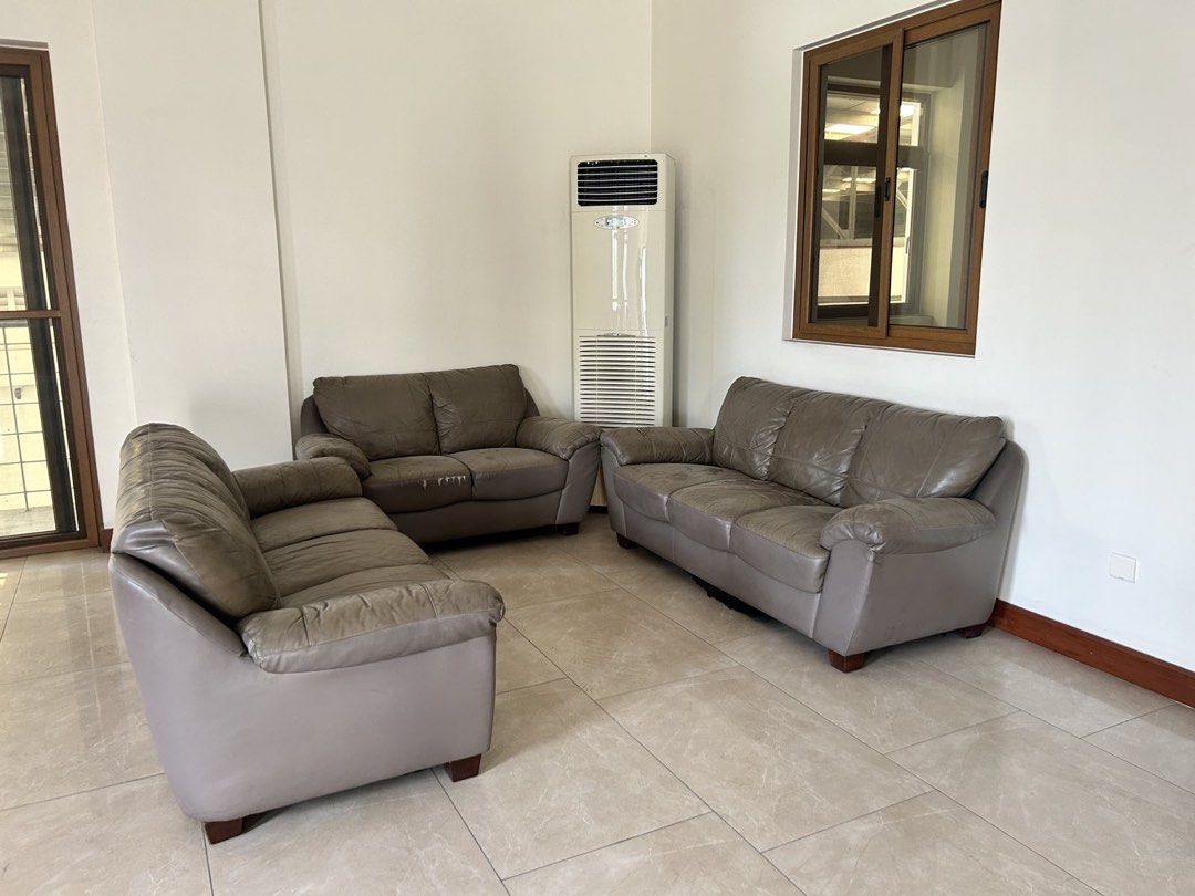 Leather Sofa Set (Category: Sofas) located in Mandaluyong City. Submitted by jamieapple (Listing ID 1451030410, Image 3). Description: - Comfortable leather sofa set - Includes: 2 3-seater and 1 2-seater - Color: Neutral grey-brown, versatile for any decor - Ideal for living rooms or waiting areas - Note: Some wear on the middle sofa cushion - Location: QC.