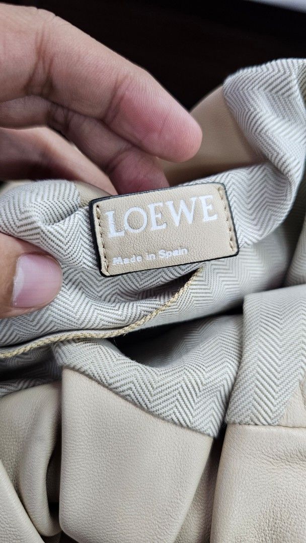 Loewe Beige Leather Hobo Bag (Category: Luxury Bags & Wallets) located in Kibawe. Submitted by Thrift_ni_Babac (Listing ID 1451021160, Image 3). Description: - Loewe Hobo Bag - Made in Spain - Color: Beige - Material: Genuine Leather - Silhouette: Soft, slouchy - Interior: Patterned lining - Features: Embossed Loewe anagram - Hardware: Silver-tone - Style: Chic everyday bag - Issue: See last photo po.