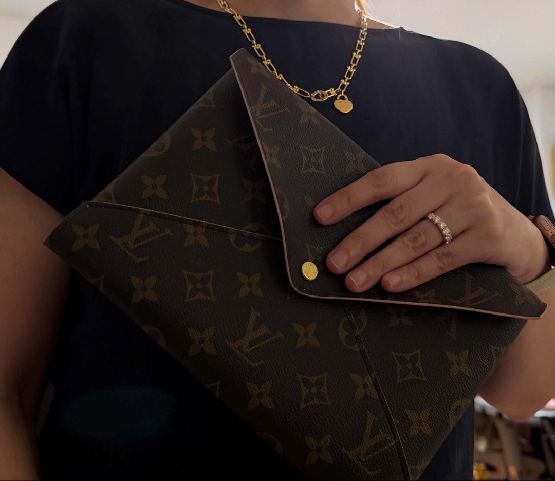 Louis Vuitton pochette kirigami (Category: Luxury Bags & Wallets) located in Quezon City. Submitted by cheriesonlineshop (Listing ID 1451025303, Image 3). Description: - Authentic Louis Vuitton Monogram Envelope Pouch - Classic brown LV print with light pink trim - Secure gold snap button closure - Perfect for organizing essentials or as a clutch - Approximate dimensions: 10 inches (length) x 7 inches (height) - No major flaws noted.