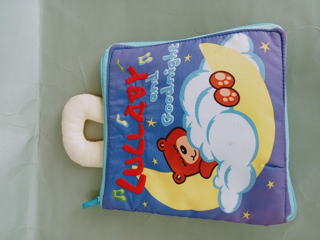 Lullaby and Goodnight Soft Book for Babies (Category: Children's Books) located in Rosario. Submitted by elysedeclutter (Listing ID 1450972064, Image 1). Description: - Interactive soft book for little ones. - Teaches daily routines: drinking milk, brushing teeth, bath time, bedtime. - Features colorful illustrations and different textures. - Zipper closure for secure pages. - Includes a loop for attaching to strollers or cribs. - Ideal for trave