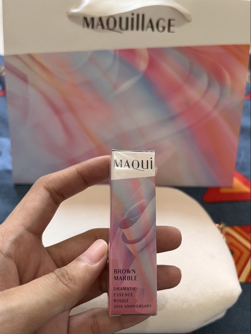 MAQuillAGE Brown Marble Dramatic Essence Rouge Lipstick & Pouch (Category: Makeup) located in Cavite. Submitted by myprsnlpreloved (Listing ID 1450977528, Image 1). Description: - Bought in Japan - MAQuillAGE Dramatic Essence Rouge Lipstick - Brand new and sealed - Shade: BR 520r Brown Marble - Limited Edition: 20th Anniversary - Includes: Soft, cream-colored MAQuillAGE makeup pouch - Lipstick Net Weight: 4g.