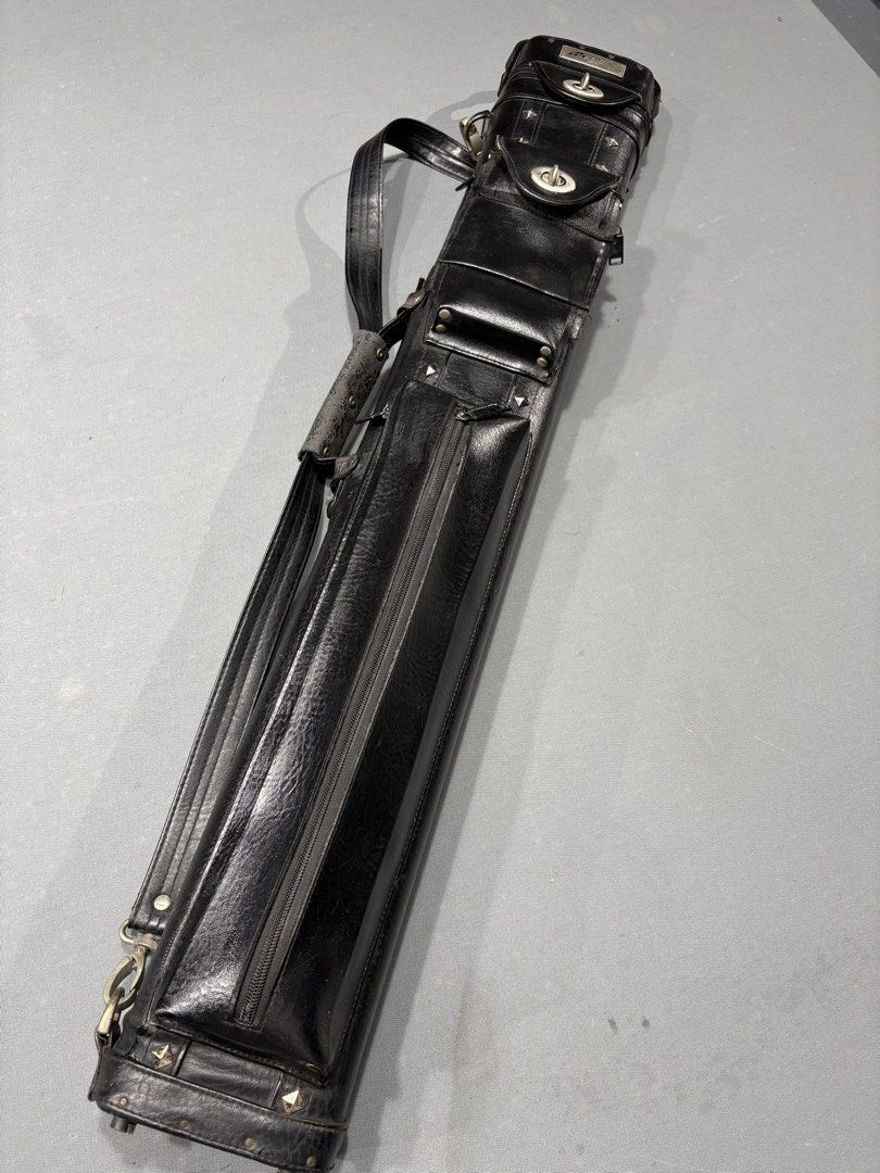 Mezz NPC35 Cue case (Category: Billiards and Bowling) located in Manila. Submitted by keeneagle-358aa6 (Listing ID 1451128376, Image 3). Description: - Stylish black leather pool cue case - Edgy studded design - Main zippered compartment - Smaller zippered pocket - Includes shoulder strap and carry handle - Interior dividers for cue organization - Shows some signs of wear on handle and exterior.