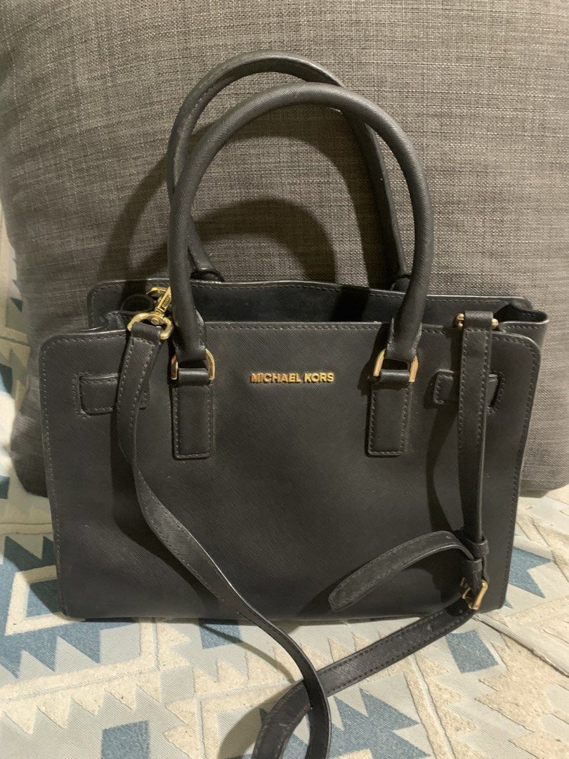 Michael Kors Black Leather Satchel Handbag (Category: Luxury Bags & Wallets) located in Liloan. Submitted by jinalyns (Listing ID 1451128347, Image 1). Description: - Authentic Michael Kors satchel bag in classic black. - Crafted from premium saffiano leather for durability and a sophisticated look. - Elegant gold-tone hardware details. - Versatile carrying options: comfortable top handles and an adjustable, detachable shoulder strap. - Thoughtfu