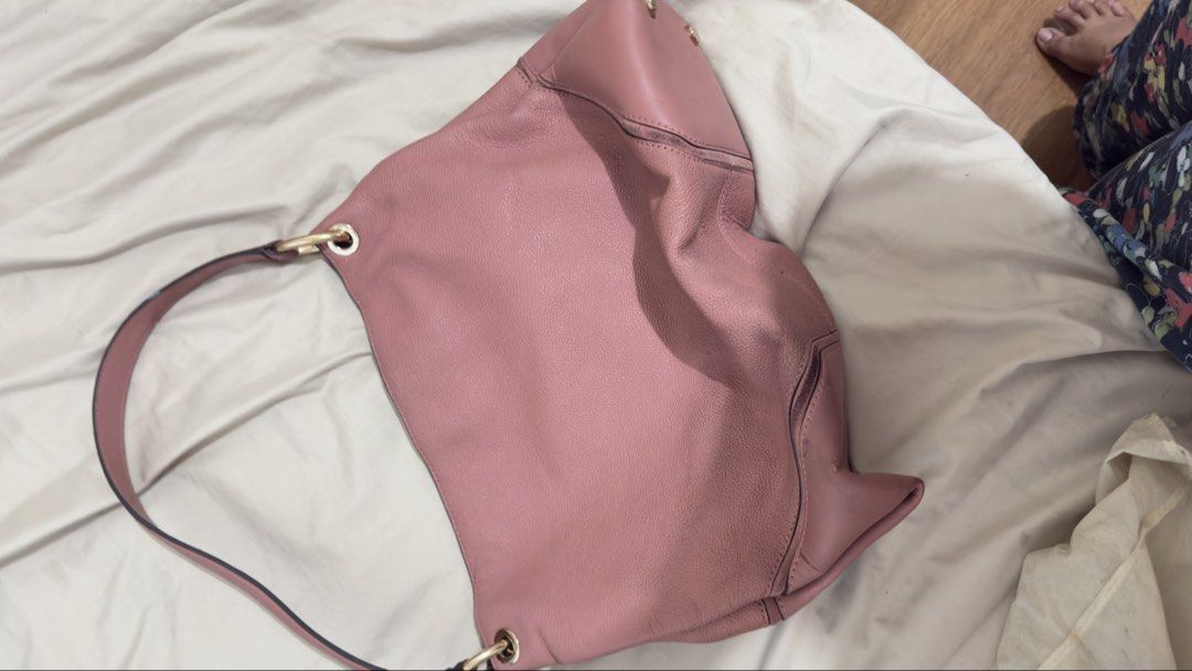 Michael Kors Pink Leather Shoulder Bag (Category: Luxury Bags & Wallets) located in Manila. Submitted by mschasaha60513 (Listing ID 1451055661, Image 3). Description: - Authentic Michael Kors shoulder bag - Lovely pink leather - Gold hardware - Single strap - Multiple interior pockets for organization - Embossed MK logo and brand name - Ideal for everyday use.