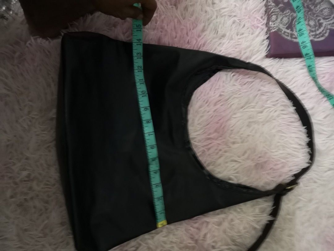 ​Minimalist Black Leather Hobo Bag / Shoulder Bag (Category: Shoulder Bags) located in Kuala Lumpur. Submitted by hasan0.2 (Listing ID 1450966244, Image 3). Description: ​Condition: Pre-loved / Excellent condition ​Color: Classic Black ​Style: Casual, Minimalist, Chic Shoulder / Hobo Bag ​Features: ​Smooth faux leather finish with a sleek look. ​Adjustable strap with a classy gold-tone buckle. ​Secure snap-button closure. ​Spacious interior, perf