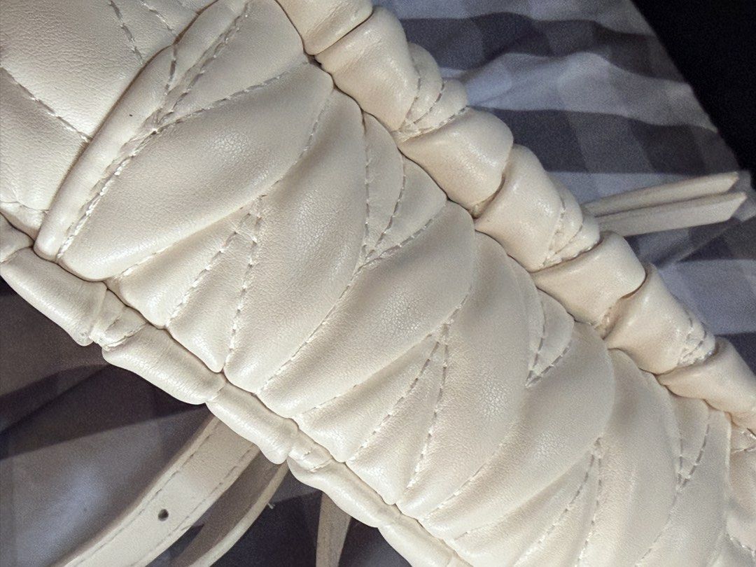 Miu Miu Quilted Cream Handbag (small sized) (Category: Luxury Bags & Wallets) located in Manila. Submitted by jasminefai11057 (Listing ID 1450998834, Image 3). Description: - Cream quilted handbag - Iconic gold Miu Miu logo - Versatile top handle and detachable shoulder strap - Elegant gold hardware details - Secure zipper closure -No box - Ideal for everyday wear or evening events.