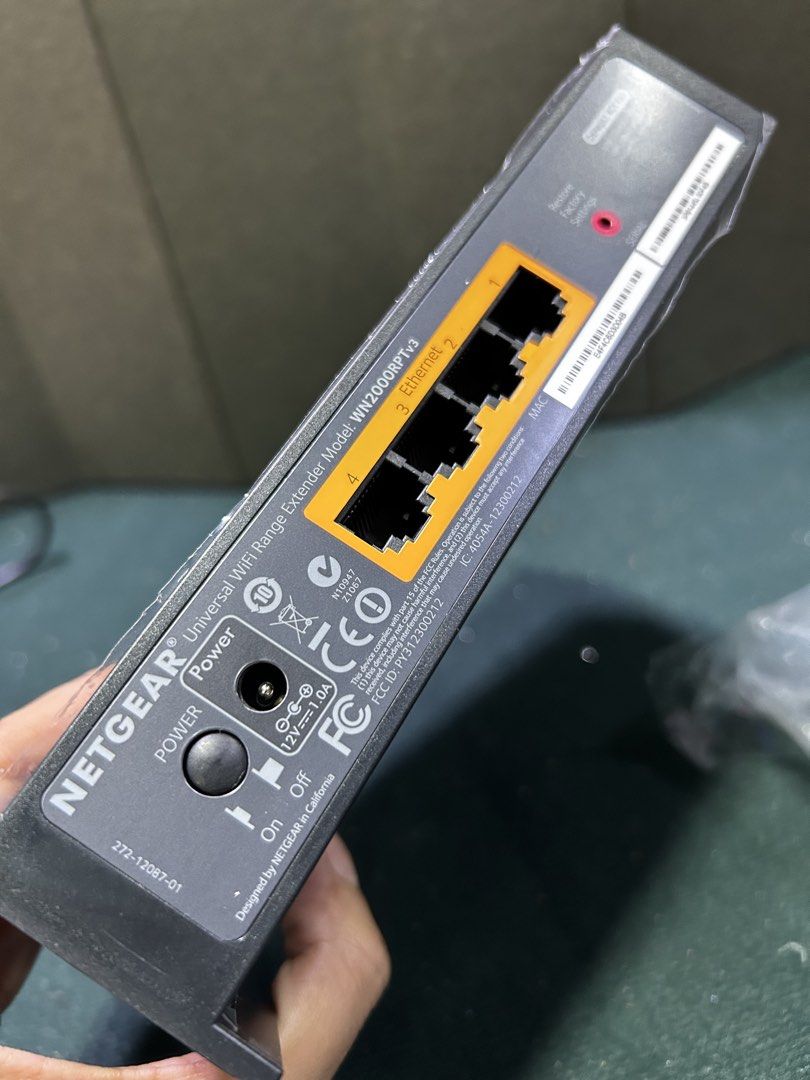 NETGEAR Universal WiFi Range Extender Model WN2000RPTv3 (Category: Networking) located in Manila. Submitted by starbalesukandjapansurplus (Listing ID 1451129342, Image 3). Description: - NETGEAR Universal WiFi Range Extender (Model WN2000RPTv3) - Extends your WiFi coverage - 4 Ethernet ports for wired devices - Includes power adapter (12V DC, 1.0A) - Power button and factory reset button - Designed by NETGEAR in California, Made in China.