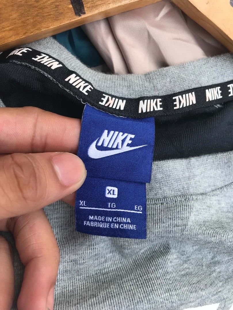 Nike Grey Crewneck Sweatshirt XL (Category: Coats, Jackets and Outerwear) located in Manila. Submitted by rhynh4rt (Listing ID 1450962045, Image 2). Description: - Grey Nike sweatshirt - Large white Nike logo on front - Raglan sleeves - Tag size: XL - Made in China - Approx. 23 inches chest measurement.