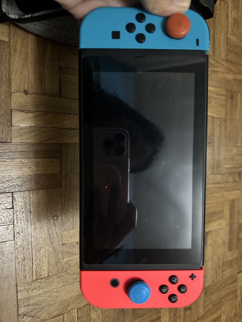 Nintendo Switch (Neon Red/Blue) Full Set with Travel Bag (Category: Nintendo) located in Rizal. Submitted by frugaliving (Listing ID 1451089430, Image 2). Description: Selling my pre-loved **Nintendo Switch (Neon Red/Blue)** package! Everything you need to play on the go or docked to your TV is included. **📦 What’s Included:** * Nintendo Switch Console (Screen protected) * Joy-Con Controllers (Left Neon Blue / Right Neon Red) * Joy-Con Analog Ca