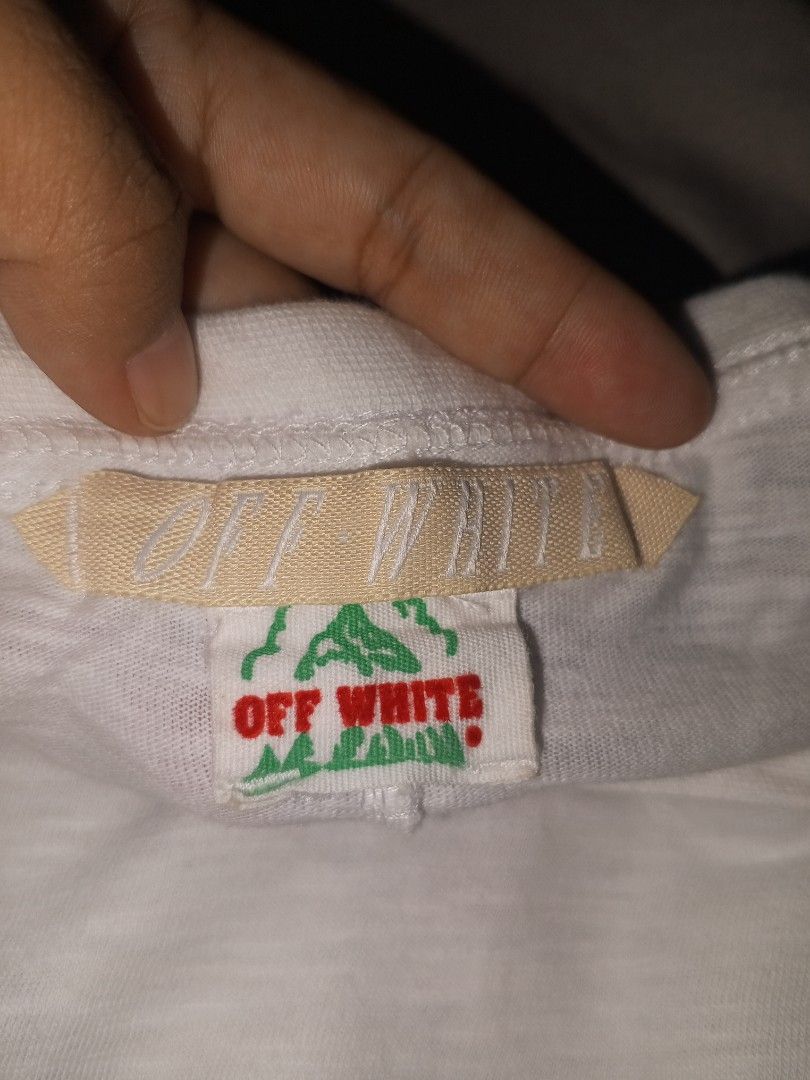 OFF-WHITE White Graphic T-Shirt Size L (Category: Tshirts & Polo Shirts ) located in Magalang. Submitted by zeiansoria64090 (Listing ID 1451068729, Image 3). Description: - OFF-WHITE graphic tee - Size: L - Iconic diagonal stripes on the back - 'WHITE' text on the back and front hem - Material: 100% Cotton - Care instructions available on tags.