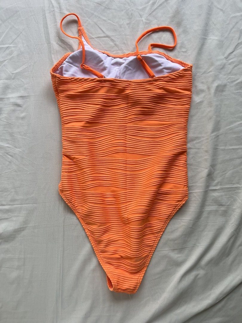 Orange Textured One-Shoulder One-Piece Swimsuit (Category: Bikinis & Swimsuits) located in Manila. Submitted by prelovedbymatchalover (Listing ID 1451126643, Image 2). Description: - Vibrant bright orange one-piece swimsuit - Trendy one-shoulder design - Textured fabric for a stylish look - Fully lined with a clean white interior - Adjustable straps at the back for a perfect fit - Size: S - Origin: Made in China.