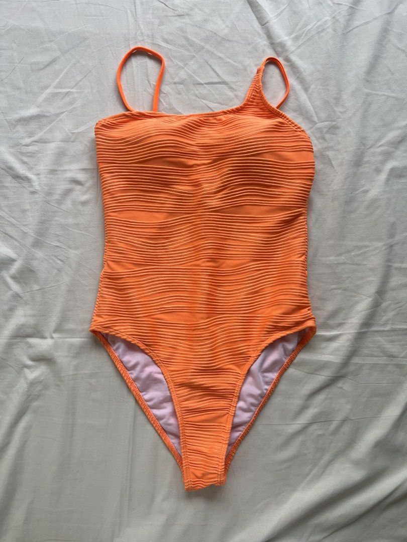 Orange Textured One-Shoulder One-Piece Swimsuit (Category: Bikinis & Swimsuits) located in Manila. Submitted by prelovedbymatchalover (Listing ID 1451126643, Image 1). Description: - Vibrant bright orange one-piece swimsuit - Trendy one-shoulder design - Textured fabric for a stylish look - Fully lined with a clean white interior - Adjustable straps at the back for a perfect fit - Size: S - Origin: Made in China.