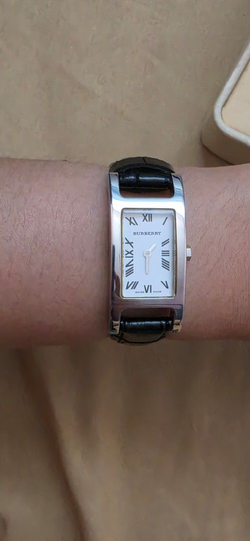 Original Burberry Rectangular Watch Black Leather Strap (Category: Women's Watches) located in Pasig City. Submitted by lfboutique (Listing ID 1450957920, Image 2). Description: - original and preloved Classic rectangular watch design - White watch face with elegant Roman numerals - Black genuine leather strap with crocodile texture - Secure silver buckle closure - Versatile for everyday wear or special occasions replaced strap damaged box pasig 