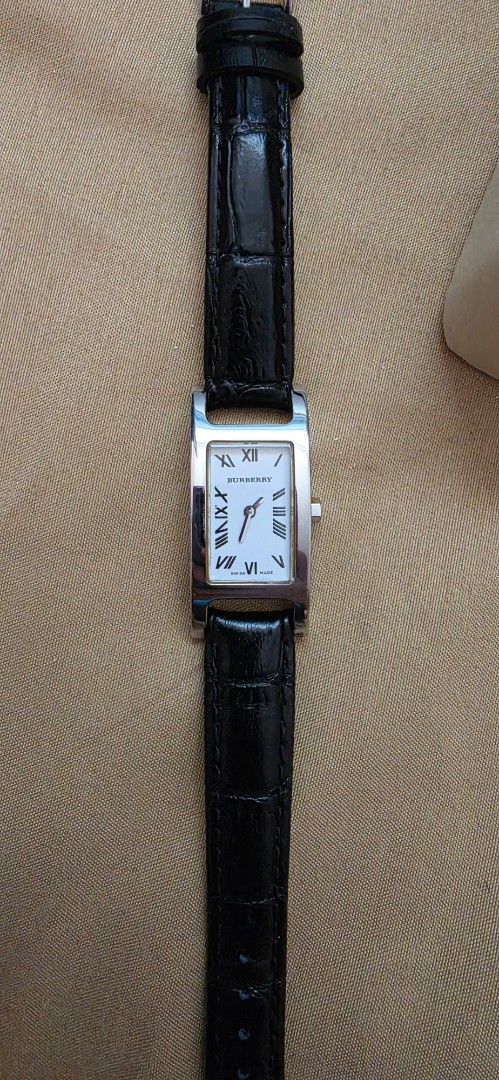 Original Burberry Rectangular Watch Black Leather Strap (Category: Women's Watches) located in Pasig City. Submitted by lfboutique (Listing ID 1450957920, Image 1). Description: - original and preloved Classic rectangular watch design - White watch face with elegant Roman numerals - Black genuine leather strap with crocodile texture - Secure silver buckle closure - Versatile for everyday wear or special occasions replaced strap damaged box pasig 