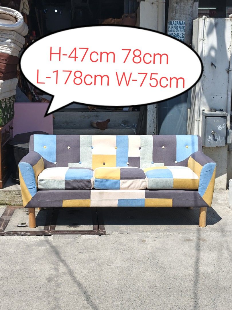 Patchwork Sofa - Colorful 3-Seater Couch (Category: Sofas) located in Valenzuela. Submitted by kendra071914 (Listing ID 1450942976, Image 1). Description: - Unique 3-seater patchwork sofa - Vibrant mix of blue, yellow, grey, and cream colors - Dimensions: Approx. L-178cm, W-75cm, H-47cm - Sturdy wooden legs - Perfect for adding a colorful statement to your living room.
