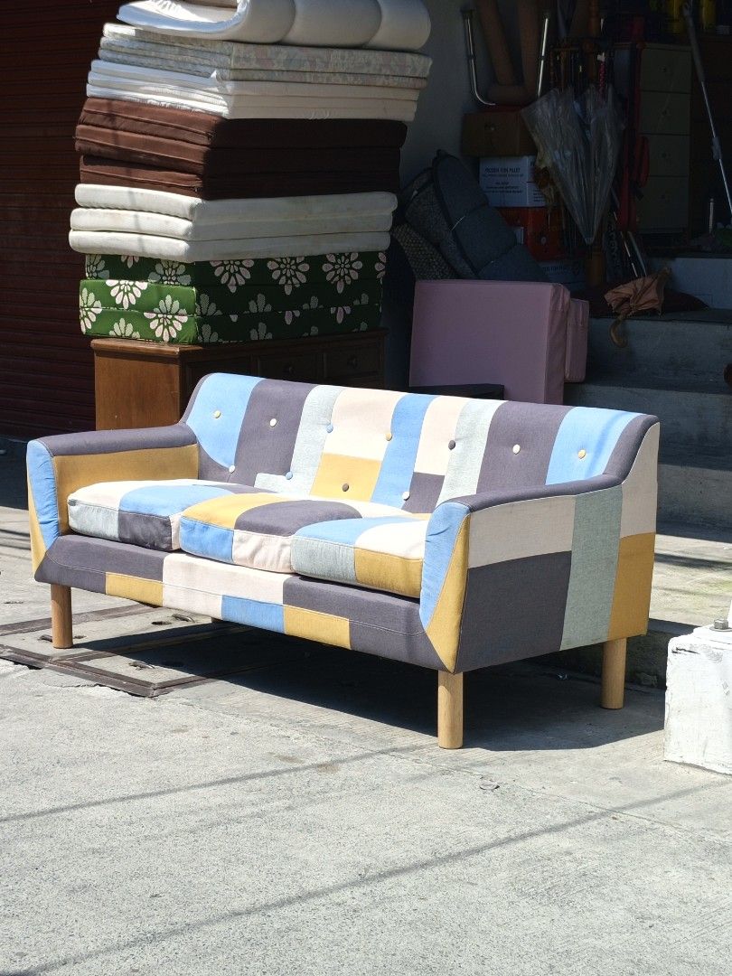 Patchwork Sofa - Colorful 3-Seater Couch (Category: Sofas) located in Valenzuela. Submitted by kendra071914 (Listing ID 1450942976, Image 2). Description: - Unique 3-seater patchwork sofa - Vibrant mix of blue, yellow, grey, and cream colors - Dimensions: Approx. L-178cm, W-75cm, H-47cm - Sturdy wooden legs - Perfect for adding a colorful statement to your living room.