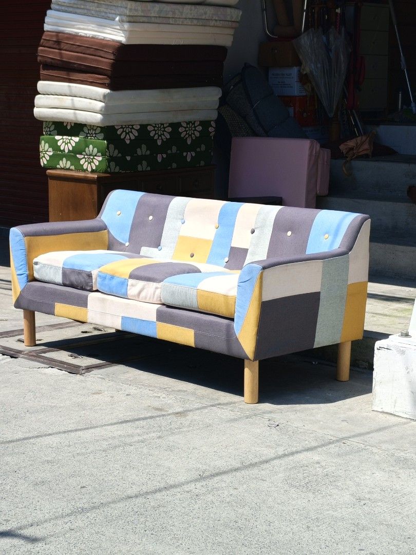 Patchwork Sofa - Colorful 3-Seater Couch (Category: Sofas) located in Valenzuela. Submitted by kendra071914 (Listing ID 1450942976, Image 3). Description: - Unique 3-seater patchwork sofa - Vibrant mix of blue, yellow, grey, and cream colors - Dimensions: Approx. L-178cm, W-75cm, H-47cm - Sturdy wooden legs - Perfect for adding a colorful statement to your living room.
