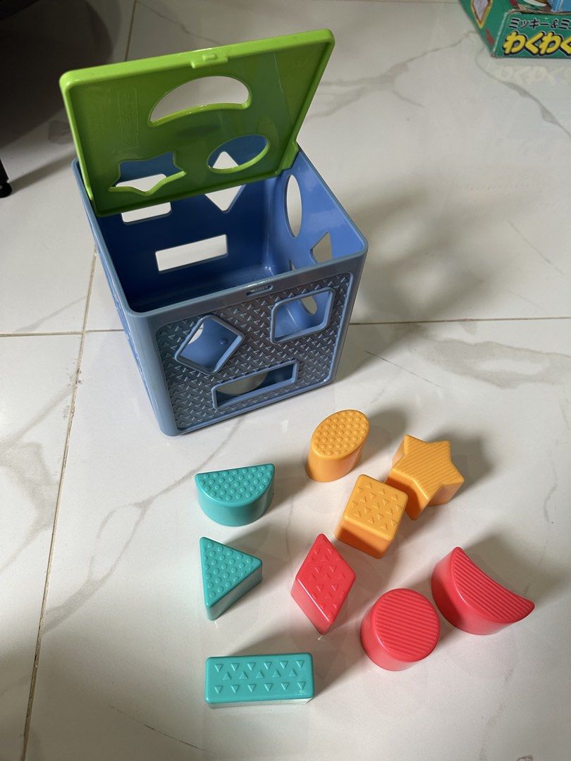 Playskool Shape Sorter Cube with 10 Blocks (Category: Educational & Learning Toys) located in Trece Martires City. Submitted by soriaalma57578 (Listing ID 1450986894, Image 2). Description: - Playskool Shape Sorter Cube - Includes 10 colorful shape blocks (star, circle, triangle, square, rectangle, diamond, etc.) - Lid opens for easy block retrieval - Perfect for teaching shapes and developing fine motor skills in young children.