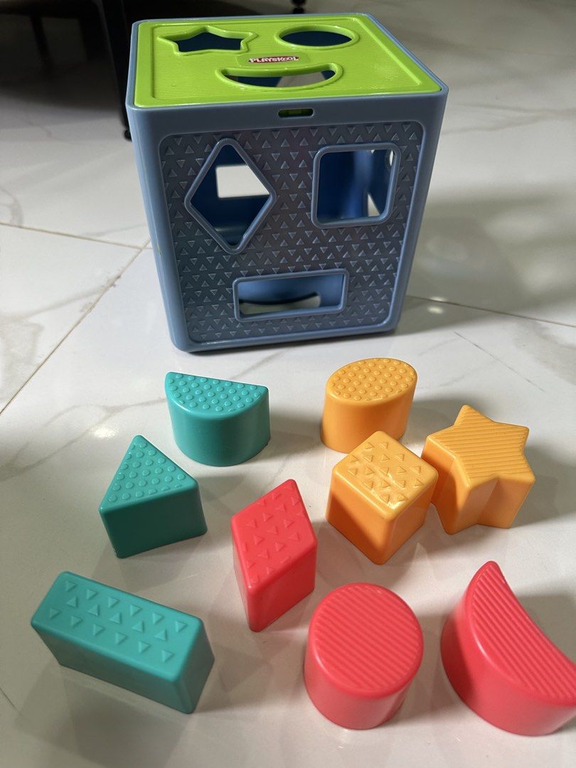 Playskool Shape Sorter Cube with 10 Blocks (Category: Educational & Learning Toys) located in Trece Martires City. Submitted by soriaalma57578 (Listing ID 1450986894, Image 3). Description: - Playskool Shape Sorter Cube - Includes 10 colorful shape blocks (star, circle, triangle, square, rectangle, diamond, etc.) - Lid opens for easy block retrieval - Perfect for teaching shapes and developing fine motor skills in young children.