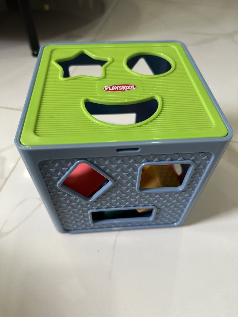 Playskool Shape Sorter Cube with 10 Blocks (Category: Educational & Learning Toys) located in Trece Martires City. Submitted by soriaalma57578 (Listing ID 1450986894, Image 1). Description: - Playskool Shape Sorter Cube - Includes 10 colorful shape blocks (star, circle, triangle, square, rectangle, diamond, etc.) - Lid opens for easy block retrieval - Perfect for teaching shapes and developing fine motor skills in young children.