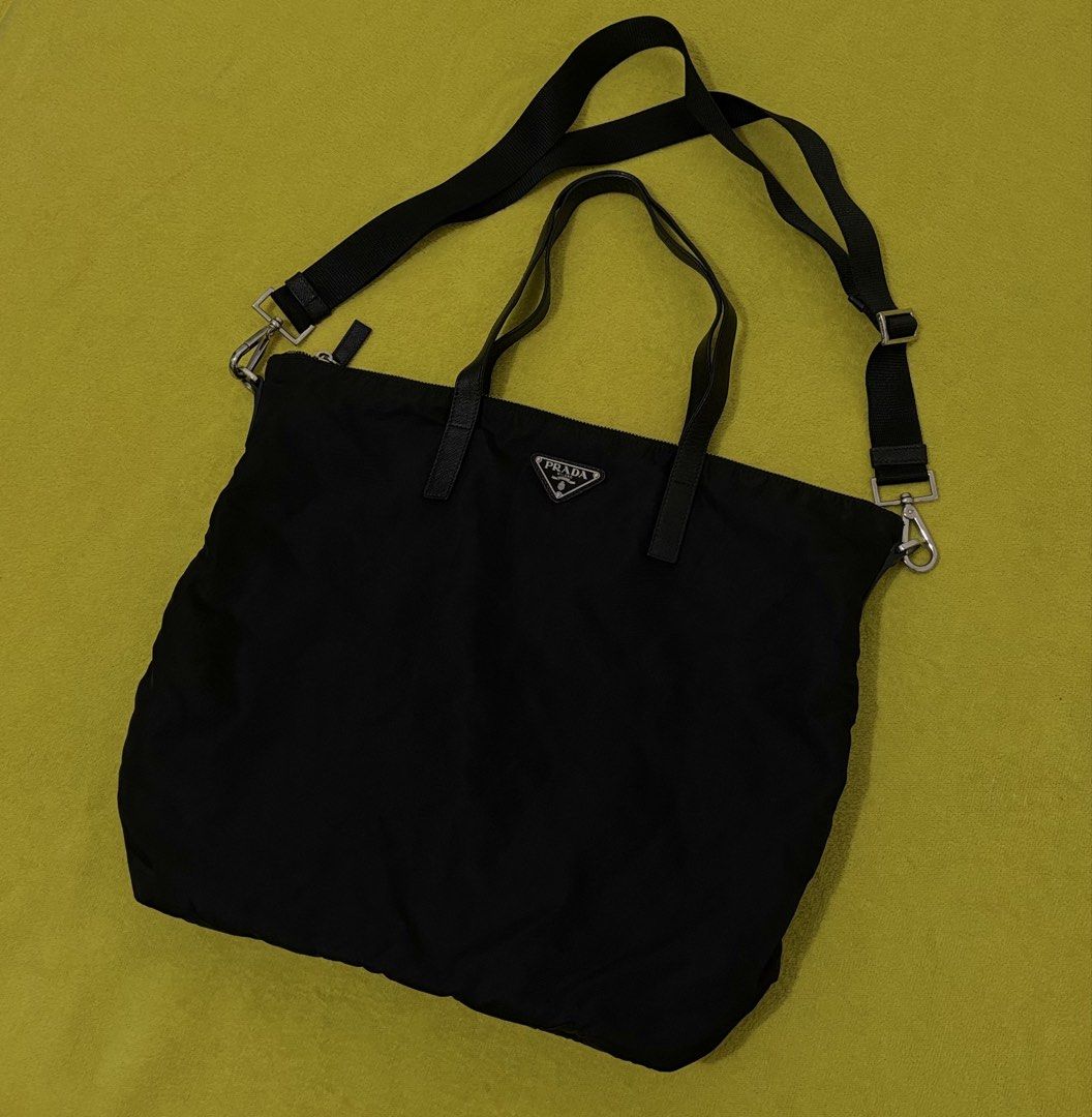 Prada Tessuto Nylon Tote Bag with Shoulder Strap (Category: Luxury Bags & Wallets) located in Bago City. Submitted by christiaaan0515 (Listing ID 1451088586, Image 1). Description: - Authentic Prada tote bag in black - Durable nylon material with elegant leather trim - Excellent condition - Size large - Versatile carrying options: top handles and detachable shoulder strap - Secure interior zip pocket for essentials - Distinctive 'riri' branded zi