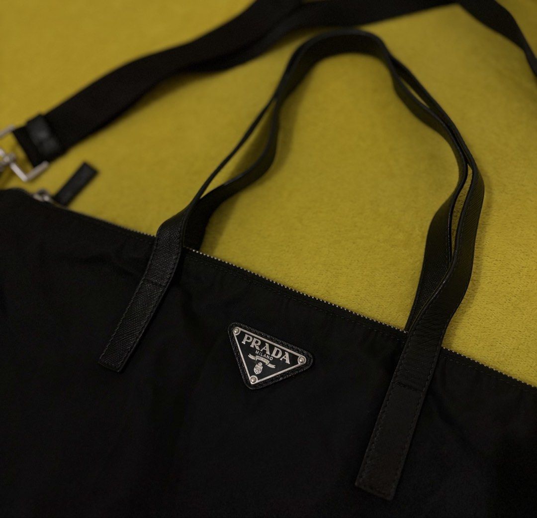 Prada Tessuto Nylon Tote Bag with Shoulder Strap (Category: Luxury Bags & Wallets) located in Bago City. Submitted by christiaaan0515 (Listing ID 1451088586, Image 2). Description: - Authentic Prada tote bag in black - Durable nylon material with elegant leather trim - Excellent condition - Size large - Versatile carrying options: top handles and detachable shoulder strap - Secure interior zip pocket for essentials - Distinctive 'riri' branded zi