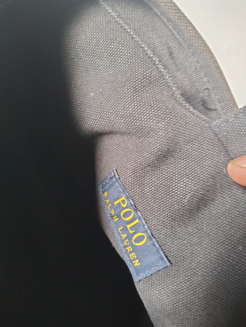 Ralph Lauren Polo Hand Bag (Category: Luxury Bags & Wallets) located in Baguio. Submitted by dapper_deals (Listing ID 1450997989, Image 3). Description: - Authentic Ralph Lauren Polo Hand bag - Color: Black - Material: 100% Cotton Canvas - Iconic white polo player logo embroidered on front - Two sturdy handles for comfortable carrying - Interior features 'Polo Ralph Lauren' tag - Care Instructions: Spot clean or hand wash only.