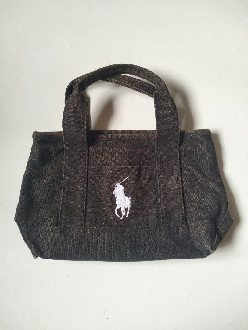 Ralph Lauren Polo Hand Bag (Category: Luxury Bags & Wallets) located in Baguio. Submitted by dapper_deals (Listing ID 1450997989, Image 1). Description: - Authentic Ralph Lauren Polo Hand bag - Color: Black - Material: 100% Cotton Canvas - Iconic white polo player logo embroidered on front - Two sturdy handles for comfortable carrying - Interior features 'Polo Ralph Lauren' tag - Care Instructions: Spot clean or hand wash only.