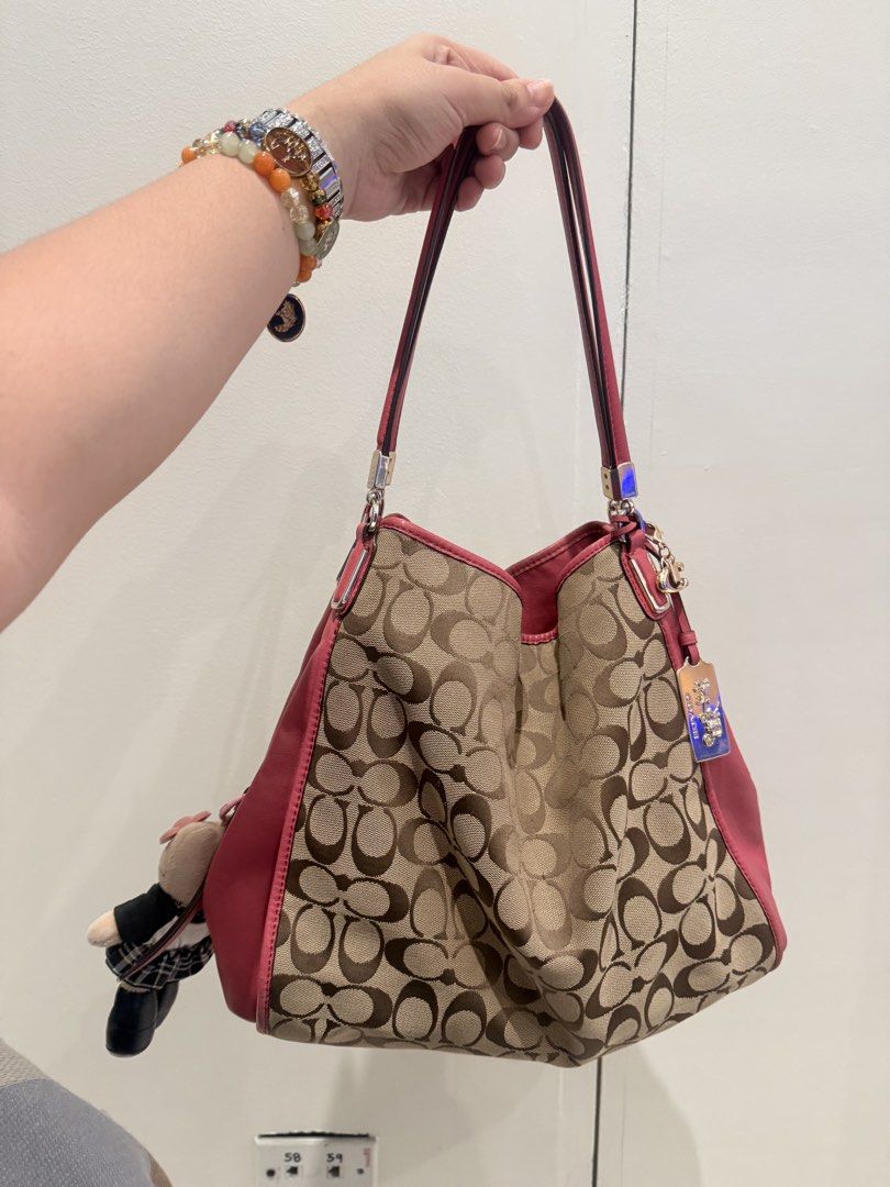 Rare Coach Pink Hobo (Category: Luxury Bags & Wallets) located in Manila. Submitted by angelcurated (Listing ID 1450945488, Image 2). Description: - Classic Coach monogram hobo bag - Chic pink leather accents and trim - Convenient side zippered pocket - Adorable Kitty and extra charm included - Ample interior space for essentials - Ideal everyday carry-all.