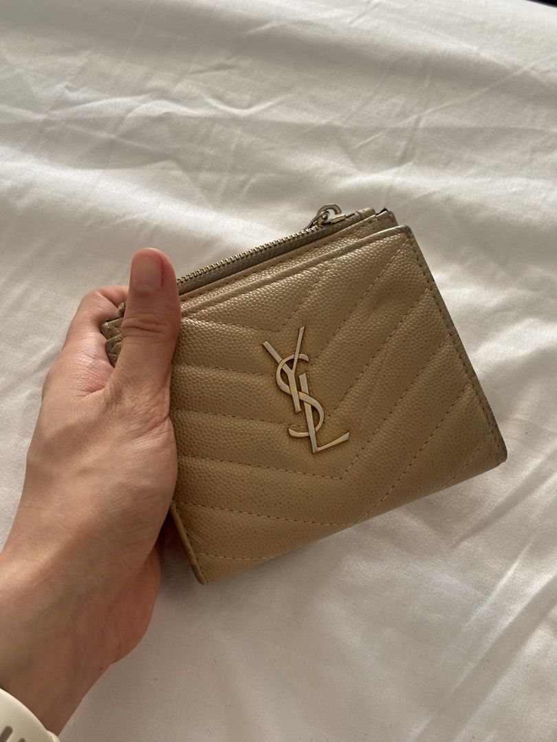 Saint Laurent YSL Quilted Wallet Beige (Category: Luxury Bags & Wallets) located in Makati City. Submitted by everythingmustgo2727 (Listing ID 1451009416, Image 1). Description: - Authentic Saint Laurent wallet in beige - Elegant quilted chevron pattern - Interior features a zip pocket and card slots - Fully functional and ready for a new owner.