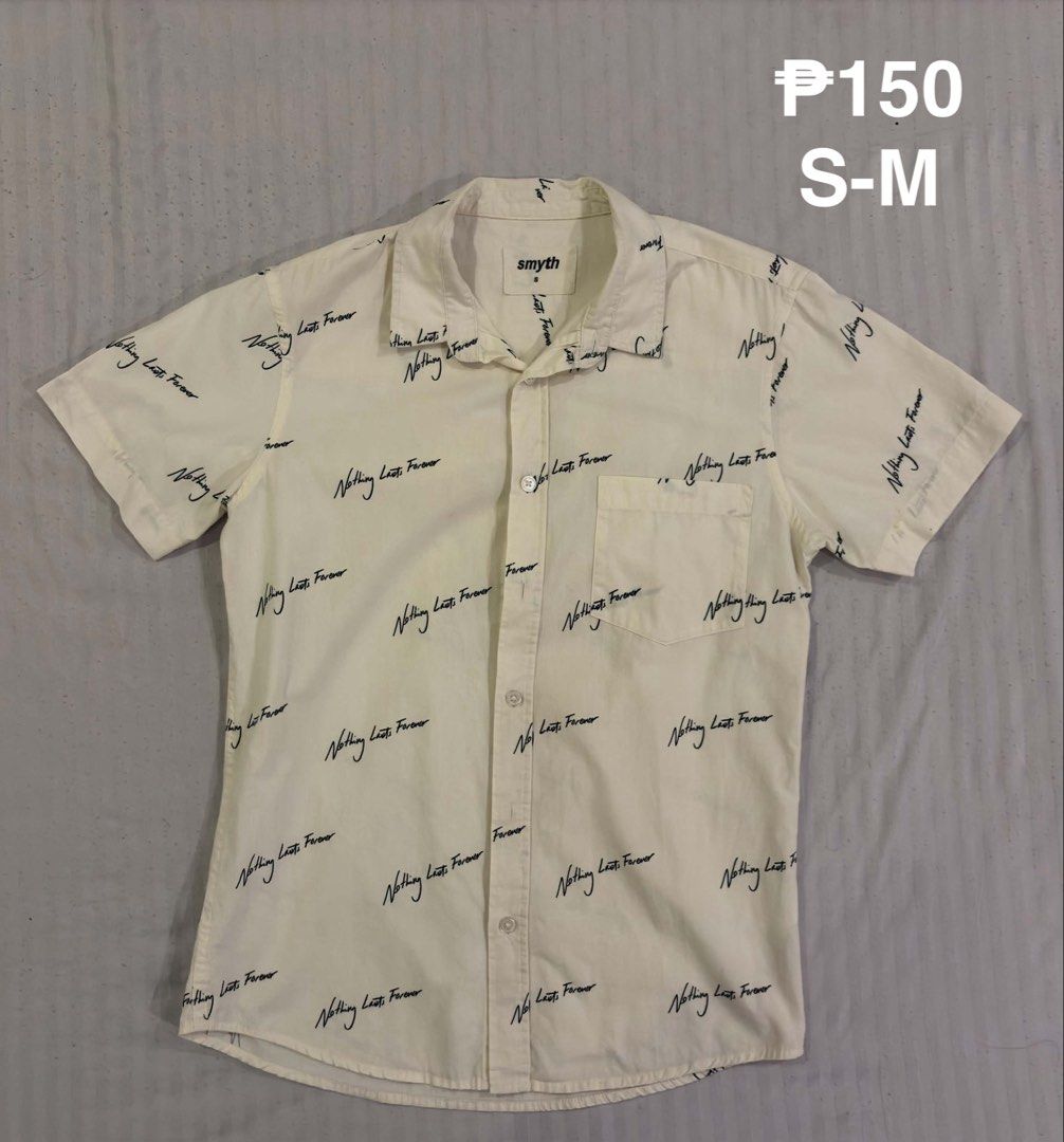 Smyth White Short Sleeve Button Up Shirt S-M (Category: Tshirts & Polo Shirts ) located in Quezon City. Submitted by 11zerofive (Listing ID 1451049245, Image 1). Description: - Smyth white short sleeve button up shirt - All-over black script print: 'Nothing Lasts Forever' - Single chest pocket - Size: S-M - Perfect for casual wear.