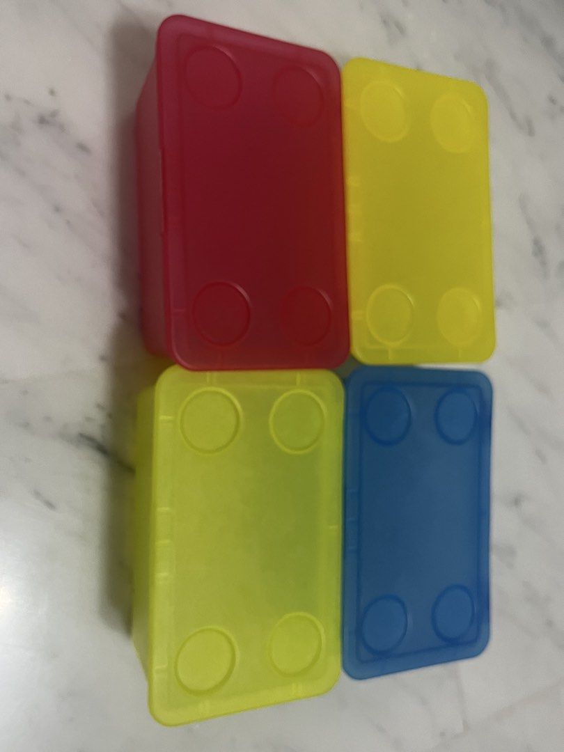 Stackable Storage Boxes (Category: Storage Boxes & Baskets) located in Singapore. Submitted by design.shopping (Listing ID 1451001113, Image 2). Description: - Set of 4 stackable storage boxes - Includes: 1 blue, 2 yellow, 1 red box - Each box comes with a secure lid - Lids feature four circular indentations for stable stacking - Ideal for organizing small items and decluttering spaces.