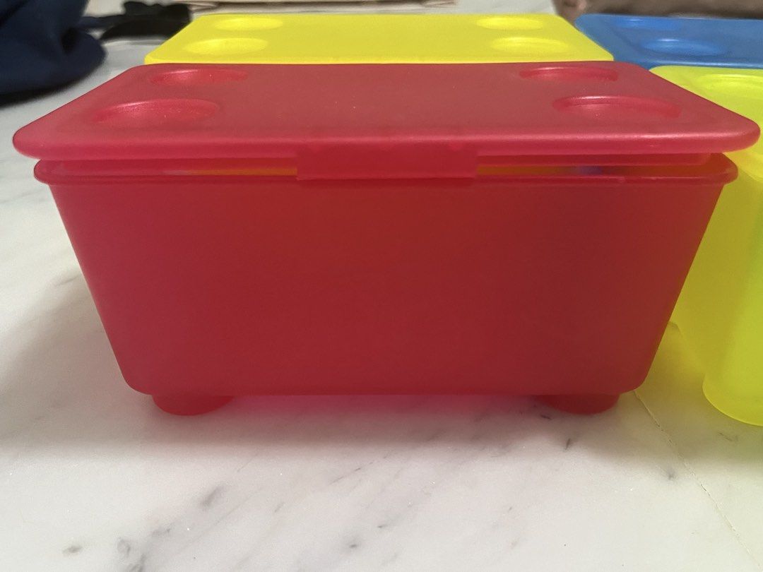 Stackable Storage Boxes (Category: Storage Boxes & Baskets) located in Singapore. Submitted by design.shopping (Listing ID 1451001113, Image 3). Description: - Set of 4 stackable storage boxes - Includes: 1 blue, 2 yellow, 1 red box - Each box comes with a secure lid - Lids feature four circular indentations for stable stacking - Ideal for organizing small items and decluttering spaces.