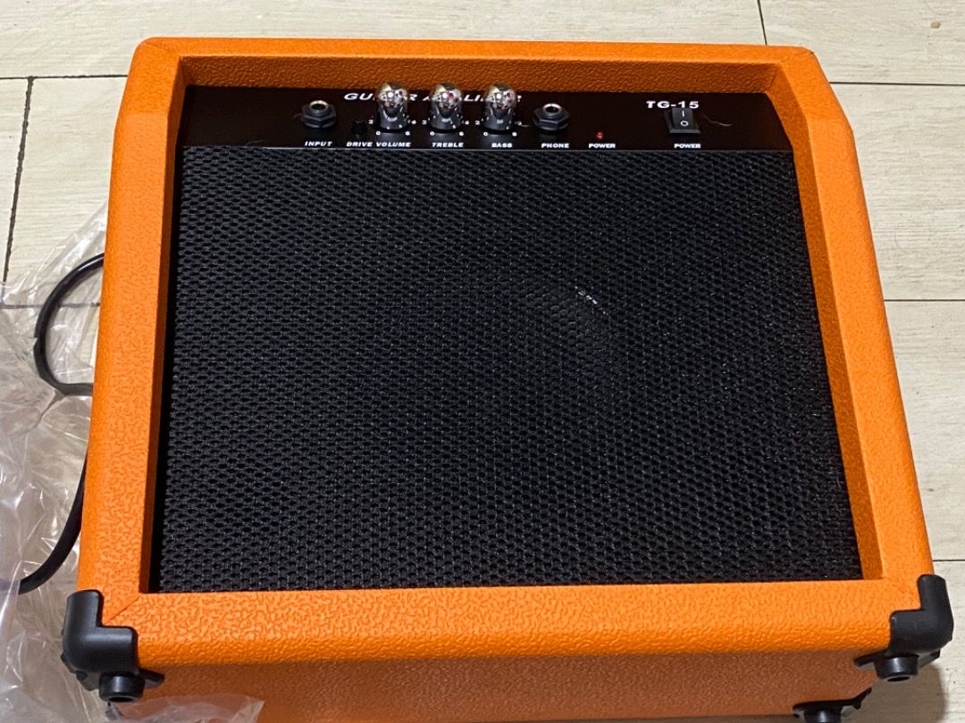 TG-15 Guitar Amplifier (Category: Soundbars, Speakers & Amplifiers) located in Caloocan City. Submitted by vastforest.a5fc8a (Listing ID 1451075787, Image 2). Description: - TG-15 Guitar Amplifier - Vibrant orange exterior - Ideal for practice and jamming - Features Volume, Drive, and Tone controls.