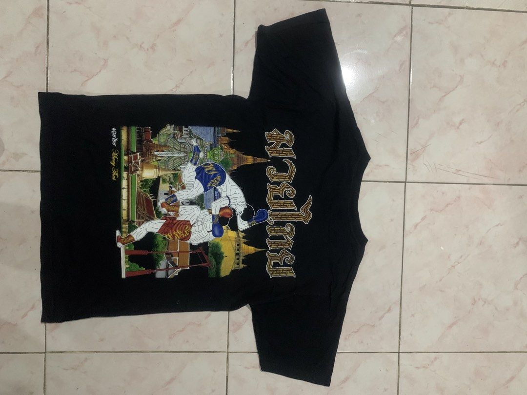 Thailand tee Muay Thai graphics (Category: Tshirts & Polo Shirts ) located in Manila. Submitted by bossbentables (Listing ID 1451058356, Image 2). Description: - Black t-shirt with 'My Dreams' brand tag. - Features a graphic print of Muay Thai fighters and a temple. - Size: F (48-42). - Ideal for martial arts enthusiasts and fans of Thai culture..